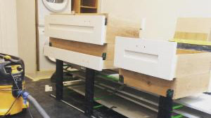 Construction site with wooden frames and tools on a concrete floor